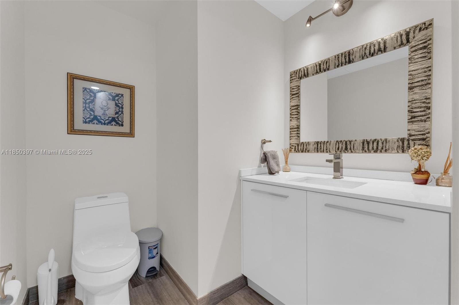 1300 Brickell Bay Drive, Unit 2511 Miami, FL 33131 - Photo 16 of 30 a bathroom with a toilet sink and mirror