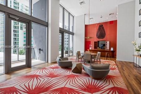 1300 Brickell Bay Drive, Unit 2511 Miami, FL 33131 - Photo 25 of 30 a living room with furniture a large window and a chandelier