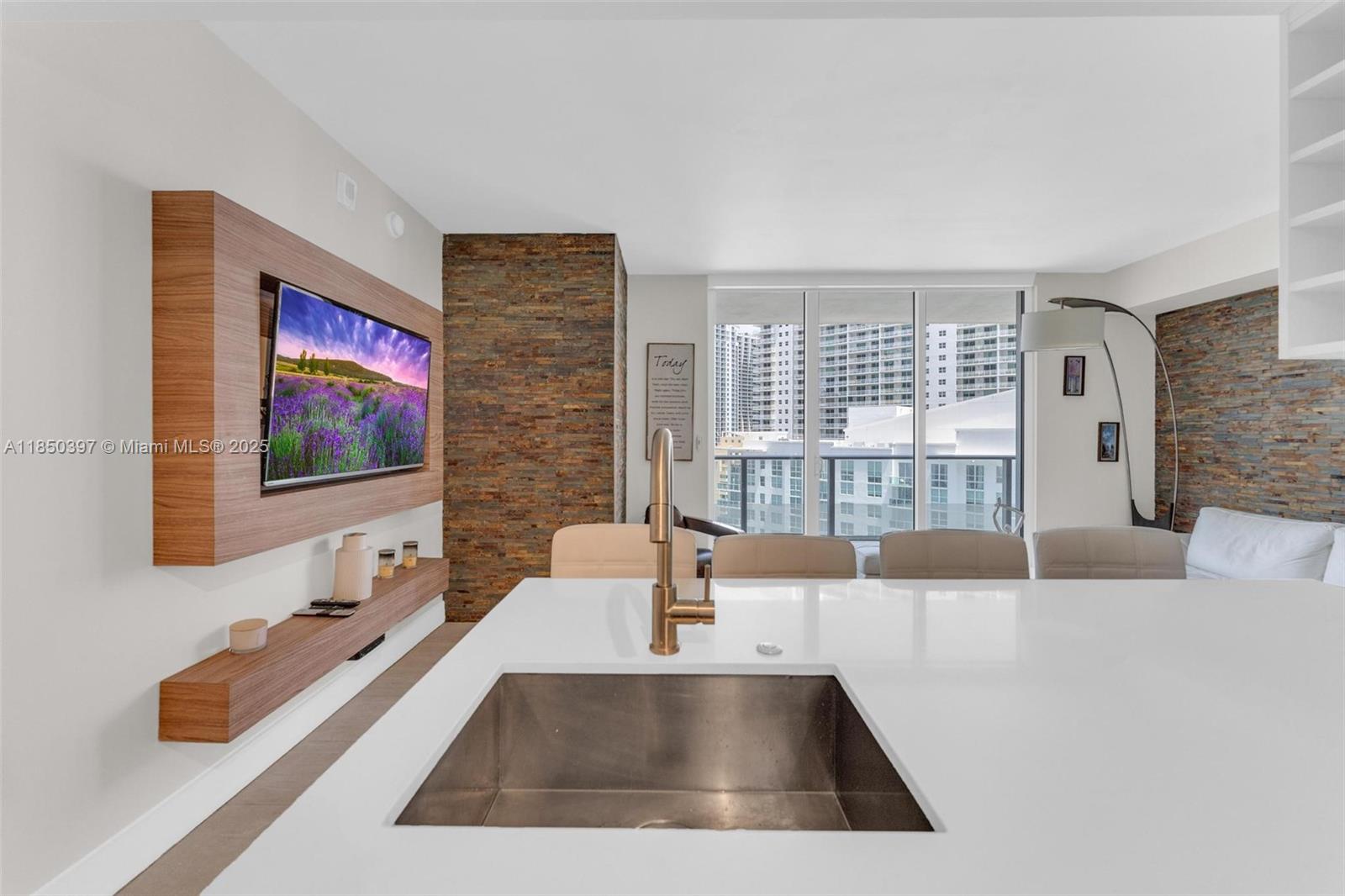 1300 Brickell Bay Drive, Unit 2511 Miami, FL 33131 - Photo 7 of 30 a living room with furniture and a flat screen tv