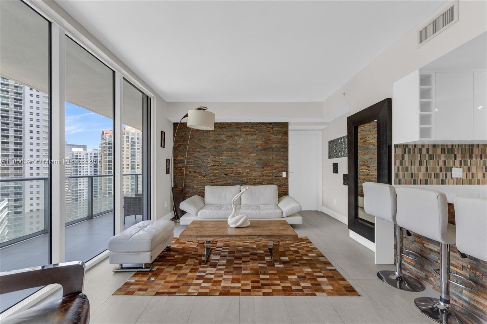 1300 Brickell Bay Drive, Unit 2511 Miami, FL 33131 - Photo 8 of 30 a living room with a couch and a coffee table