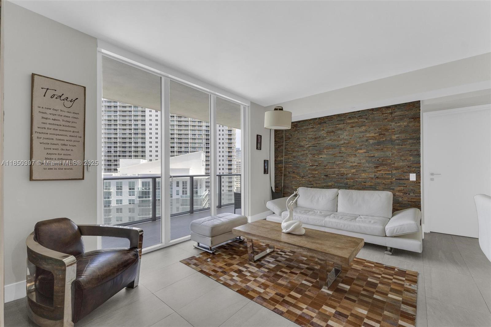 1300 Brickell Bay Drive, Unit 2511 Miami, FL 33131 - Photo 9 of 30 a living room with furniture and a rug