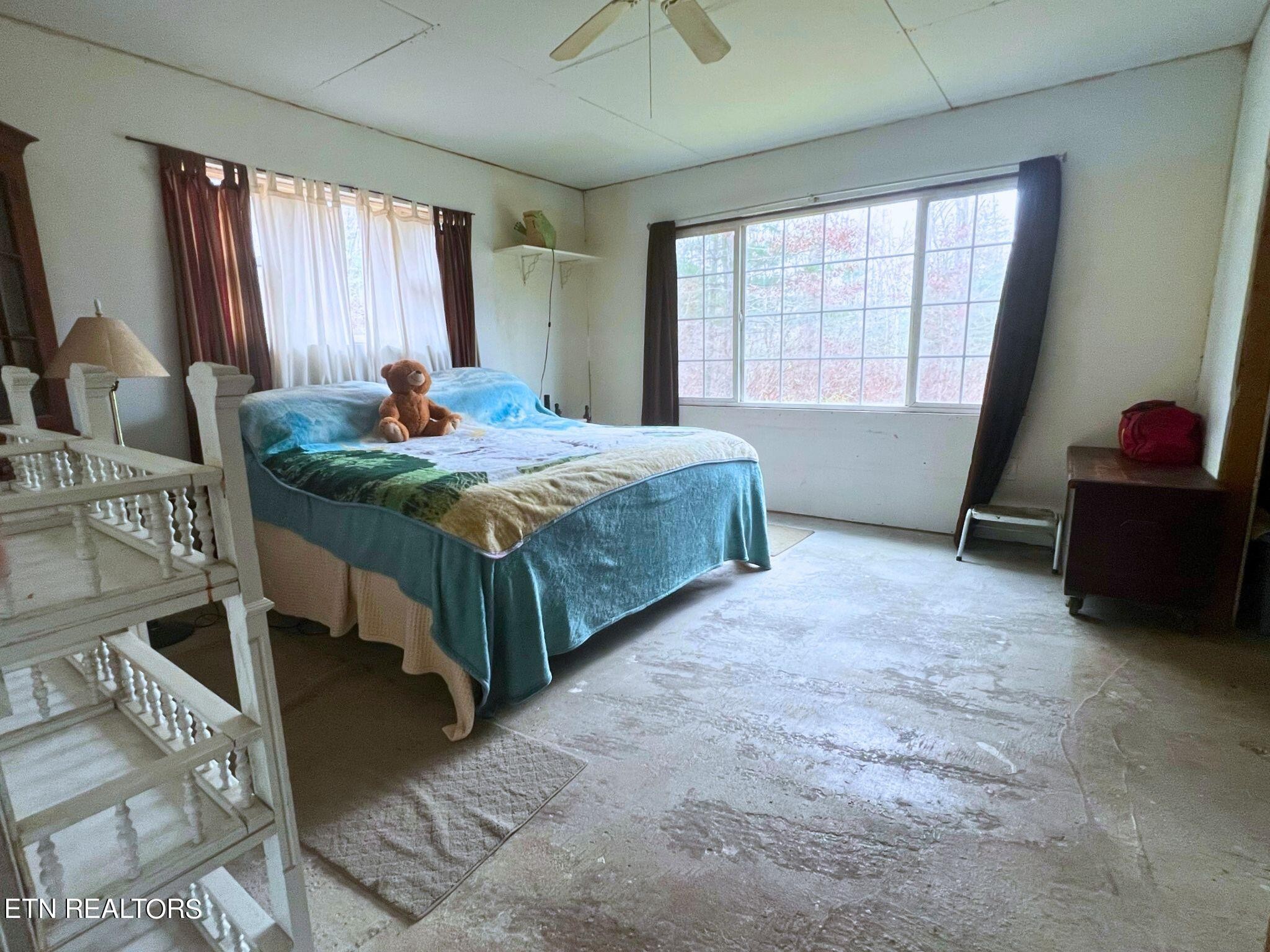109 Nelson Road Lancing, TN 37770 - Photo 17 of 30 a bed sitting in a room next to a window