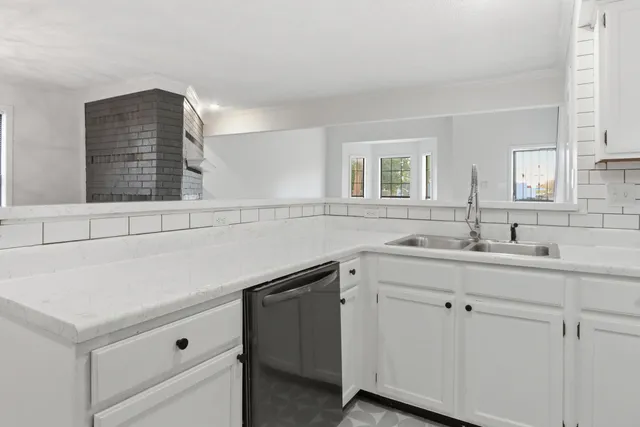 a utility room with cabinets and washer dryer