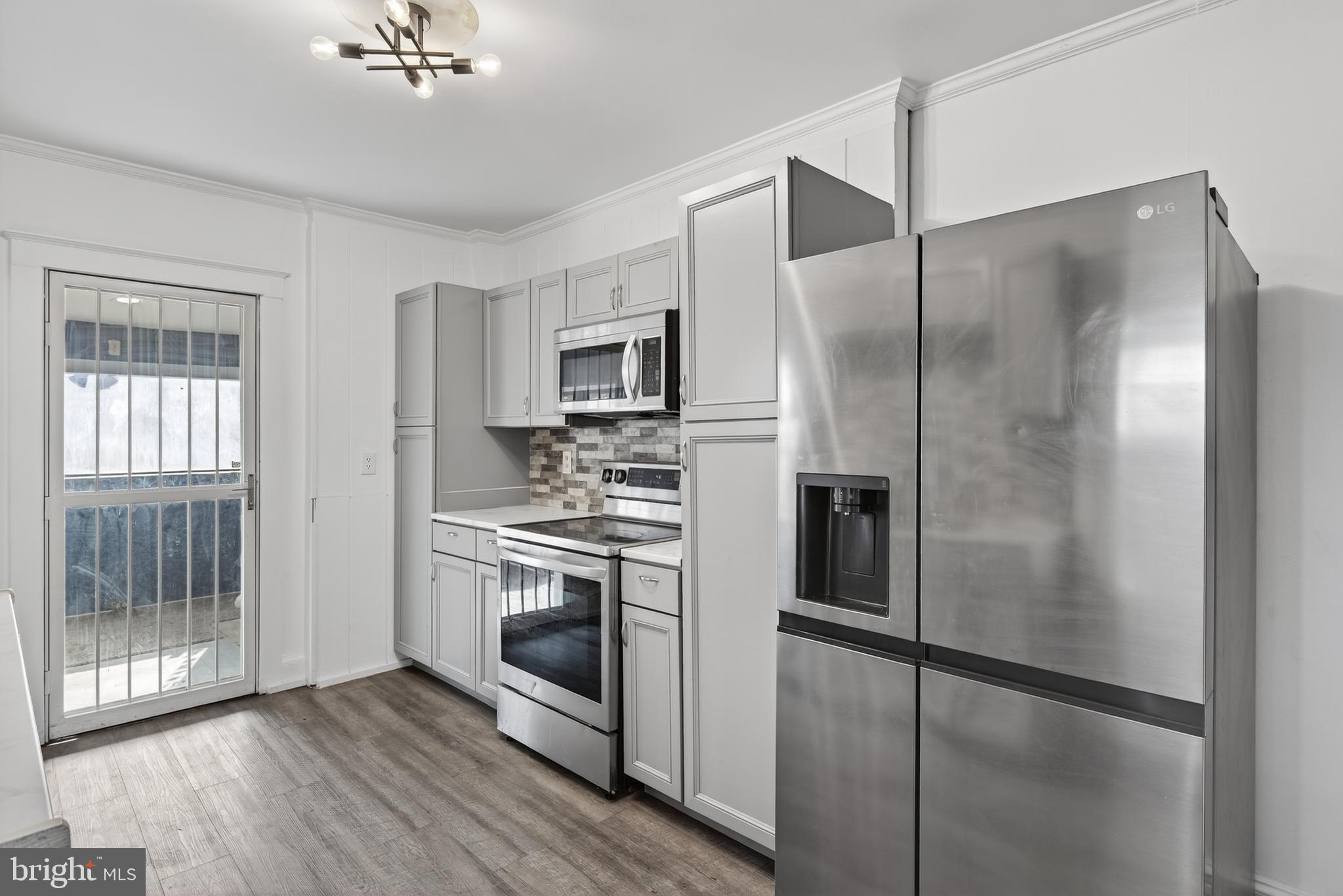 724 York Street York, PA 17403 - Photo 12 of 28 a kitchen with stainless steel appliances a refrigerator a stove a sink and white cabinets