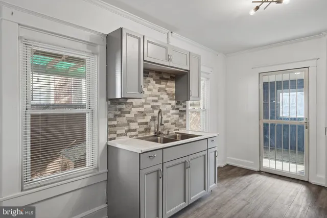 a kitchen with stainless steel appliances granite countertop a sink stove and cabinets