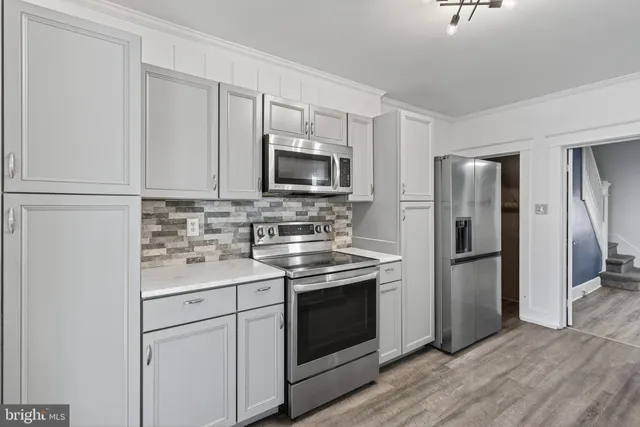 a kitchen with a sink stove and refrigerator