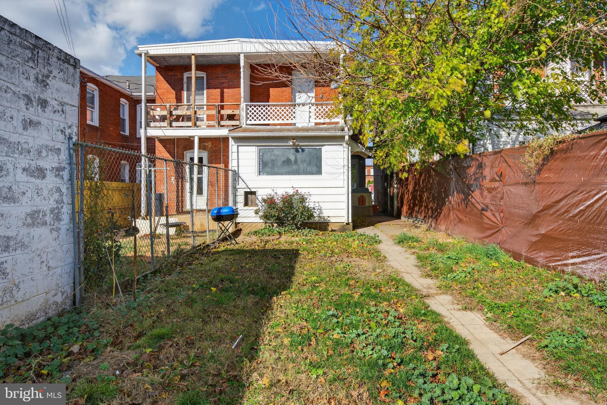 724 York Street York, PA 17403 - Photo 28 of 28 a view of a house with brick walls plants and large tree
