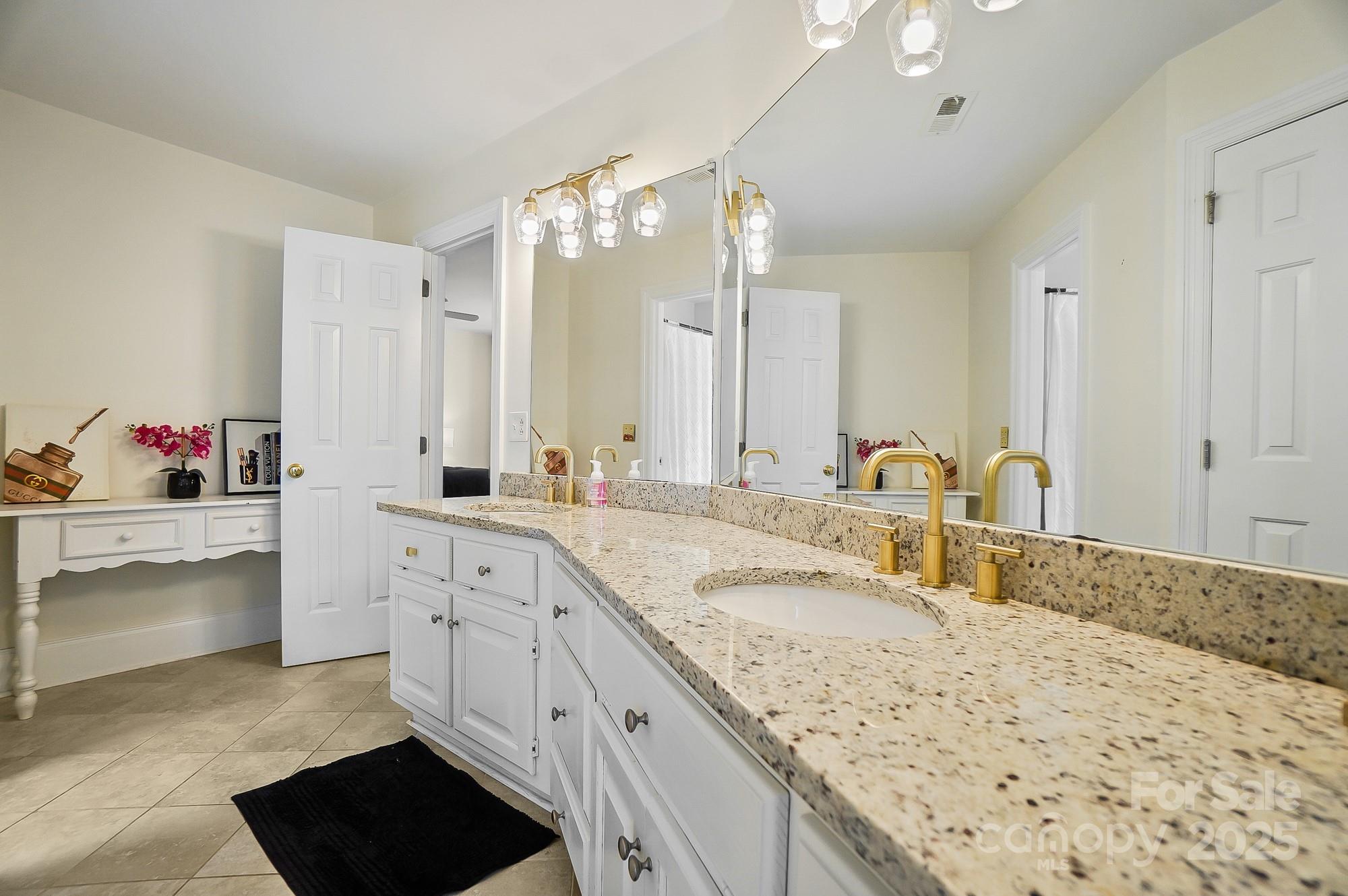 469 Valley Run Road Waxhaw, NC 28173 - Photo 34 of 48 a bathroom with a sink double vanity granite and a bathtub