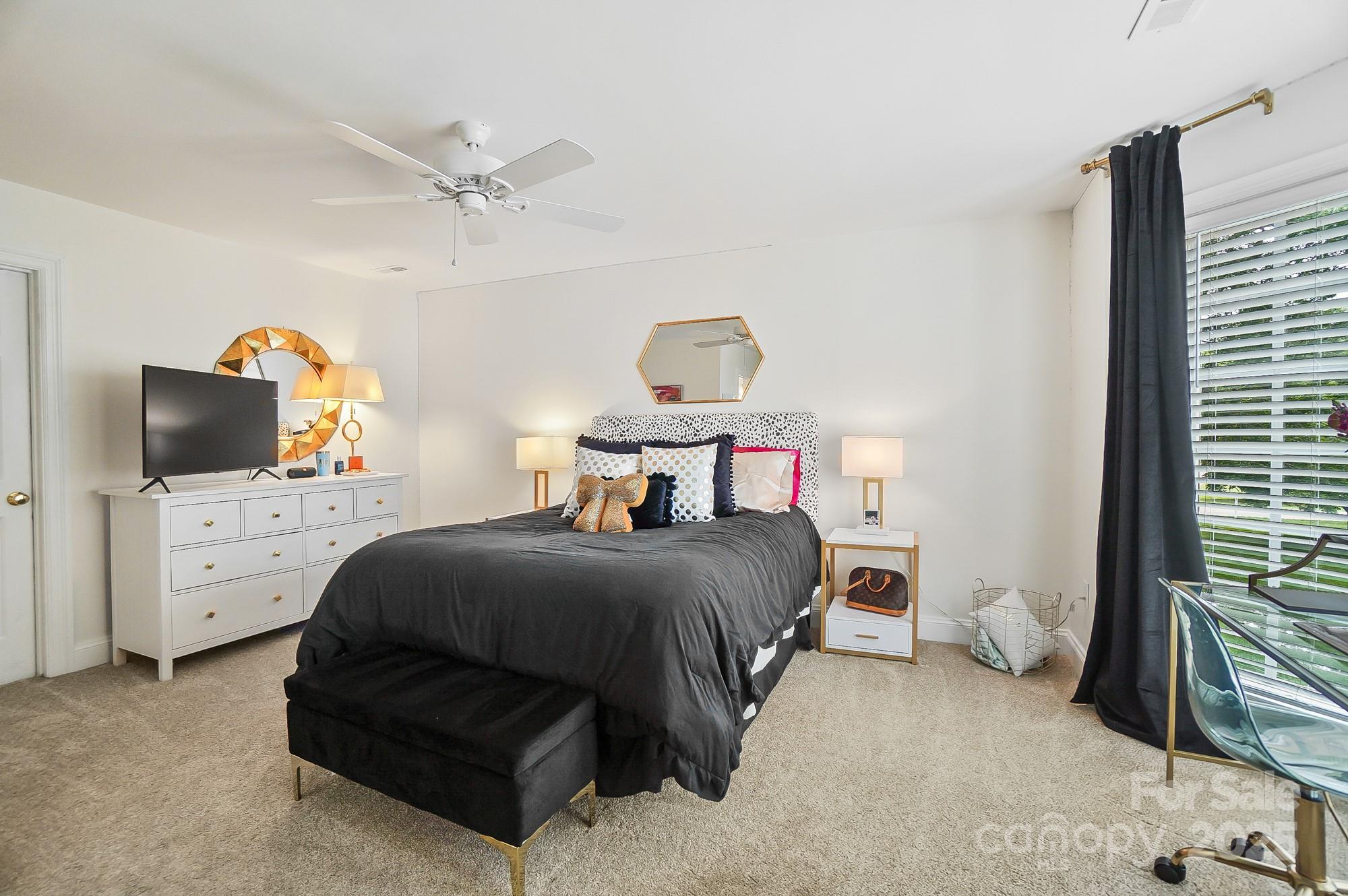 469 Valley Run Road Waxhaw, NC 28173 - Photo 37 of 48 a bedroom with a bed and flat screen tv