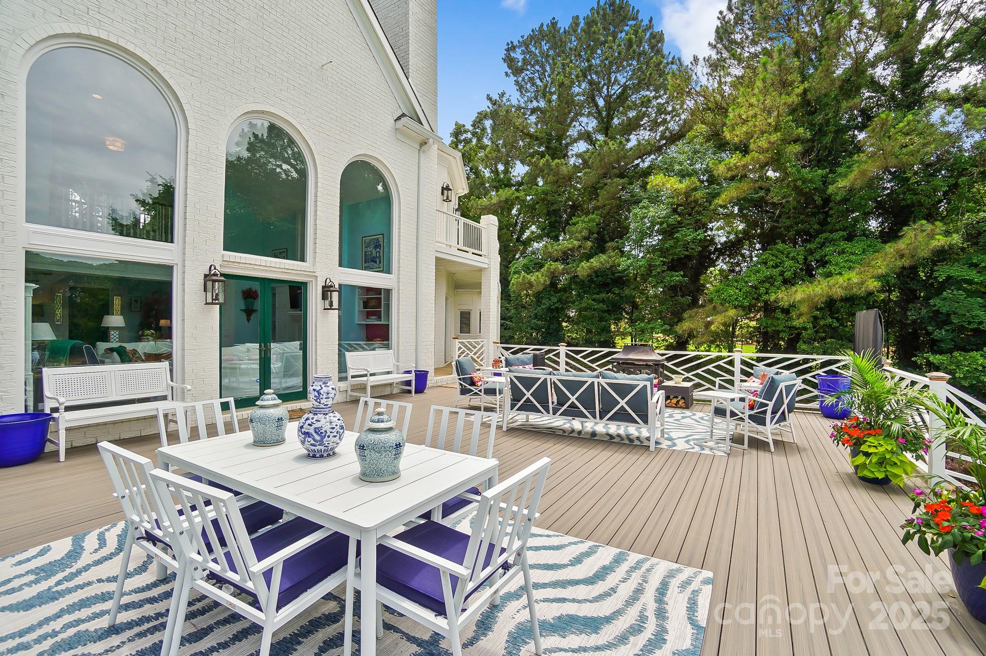 469 Valley Run Road Waxhaw, NC 28173 - Photo 45 of 48 a view of a patio with dining table and chairs with wooden floor and fence