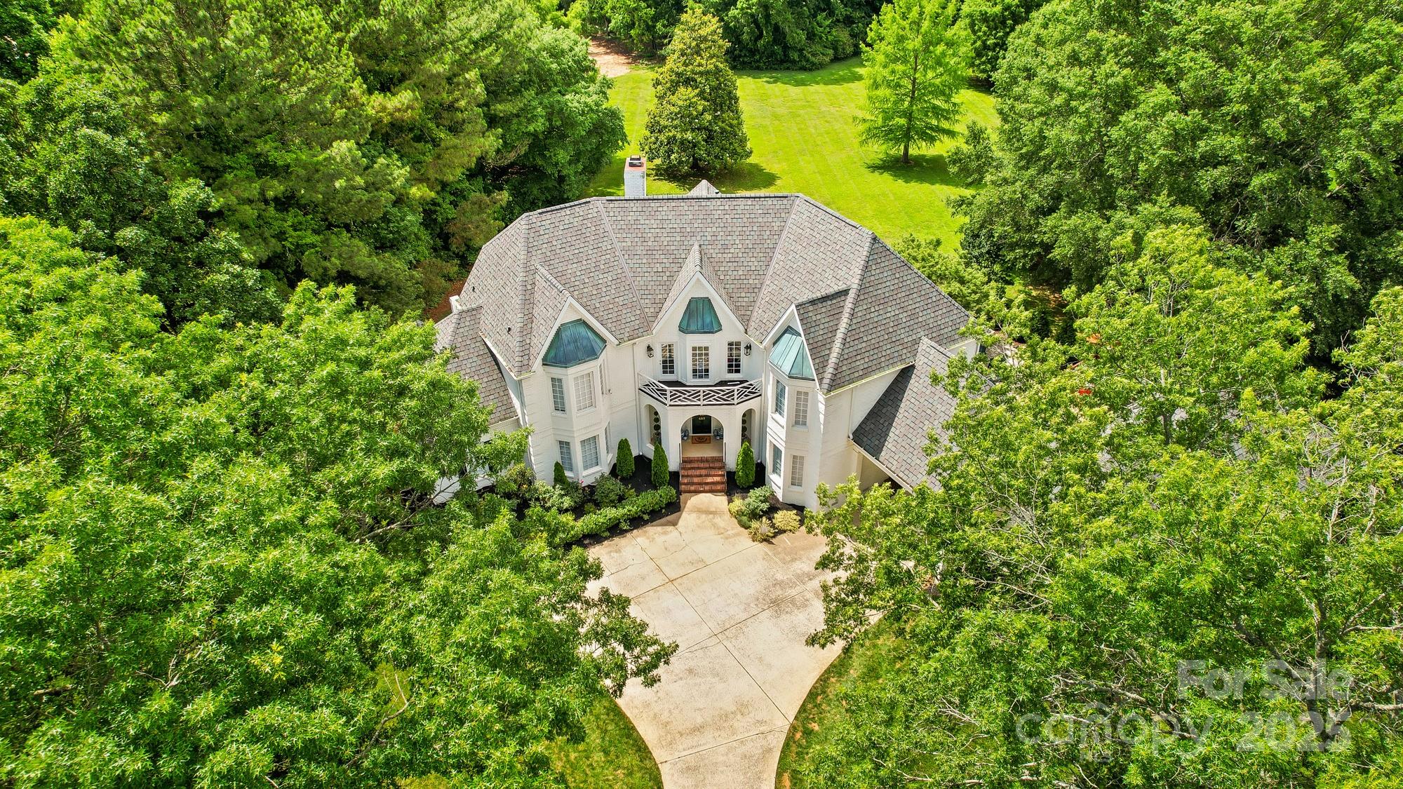 469 Valley Run Road Waxhaw, NC 28173 - Photo 6 of 48 an aerial view of a house with a yard and large trees