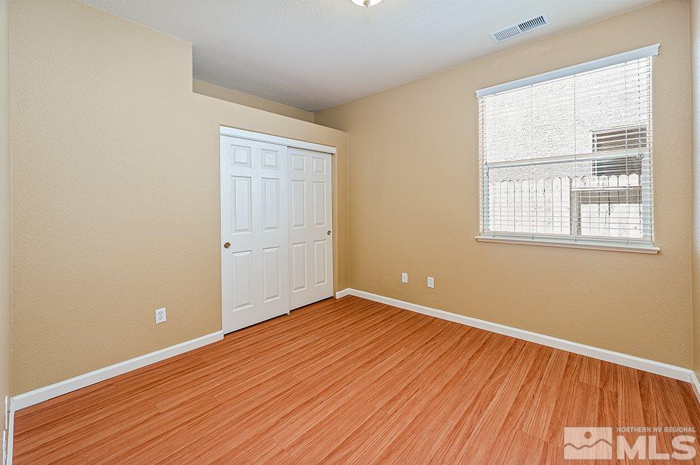 1778 Cavern Drive Reno, NV 89521 - Photo 12 of 15 an empty room with wooden floor and windows