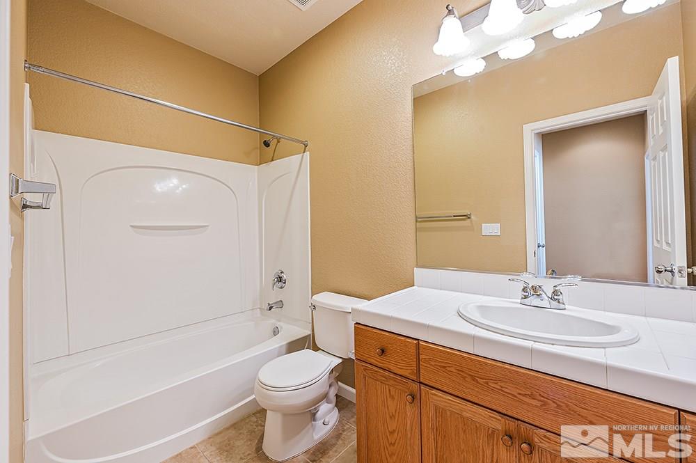 1778 Cavern Drive Reno, NV 89521 - Photo 13 of 15 a bathroom with a sink a toilet and shower