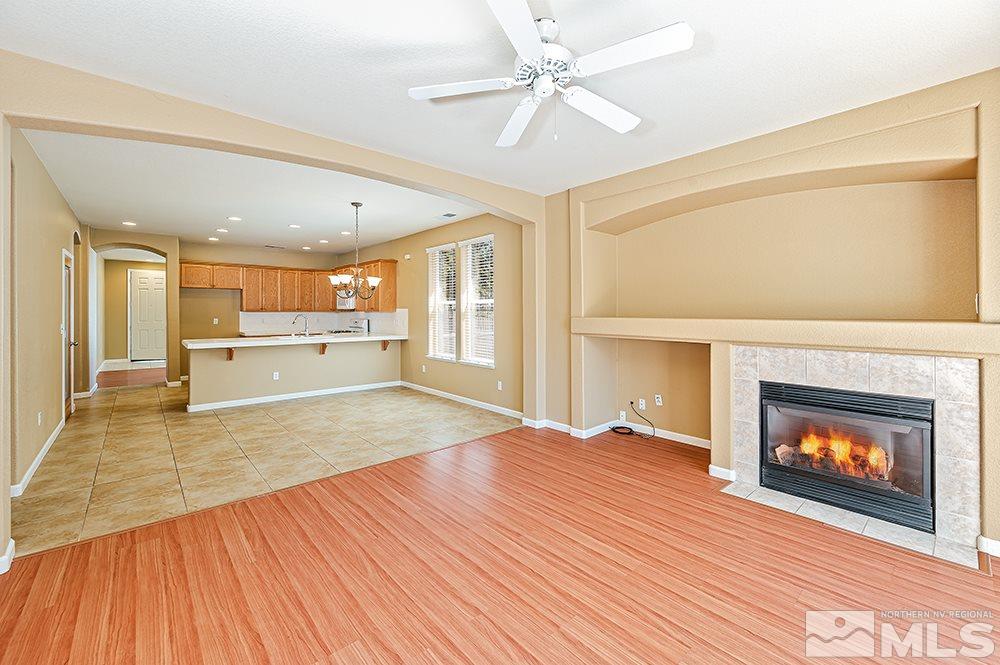 1778 Cavern Drive Reno, NV 89521 - Photo 3 of 15 a view of an empty room with a fireplace and a ceiling fan