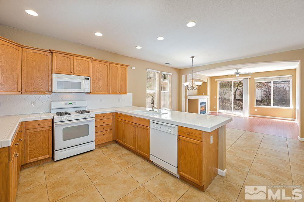 1778 Cavern Drive Reno, NV 89521 - Photo 4 of 15 a kitchen with a stove sink and cabinets