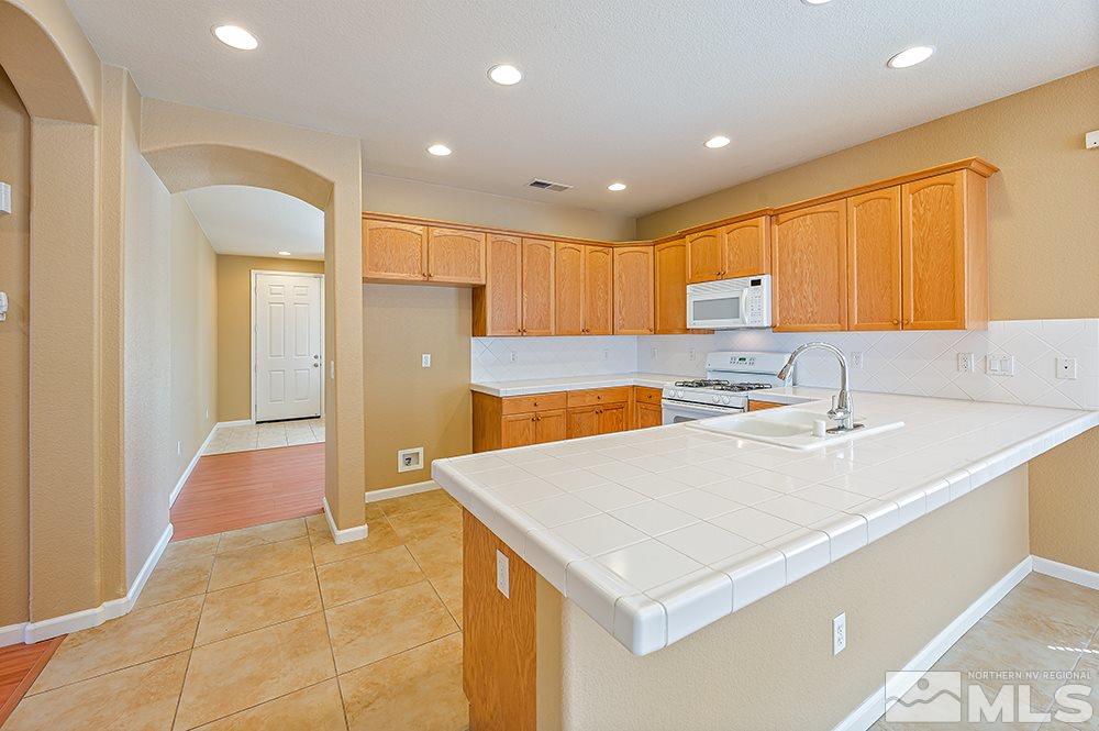 1778 Cavern Drive Reno, NV 89521 - Photo 5 of 15 a kitchen with a sink a refrigerator and a sink