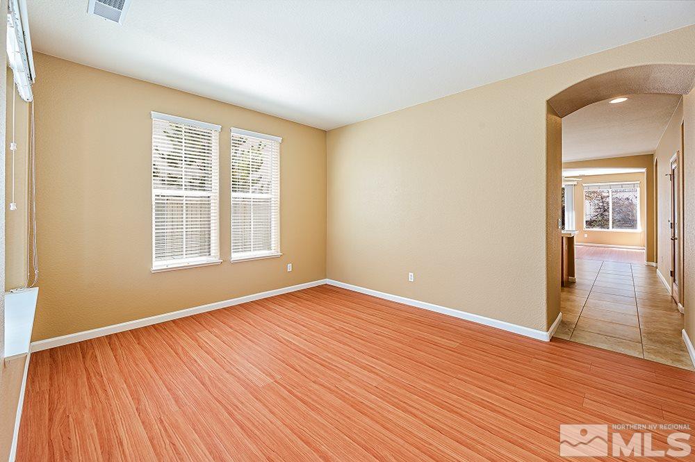 1778 Cavern Drive Reno, NV 89521 - Photo 6 of 15 a view of an empty room with wooden floor and a window