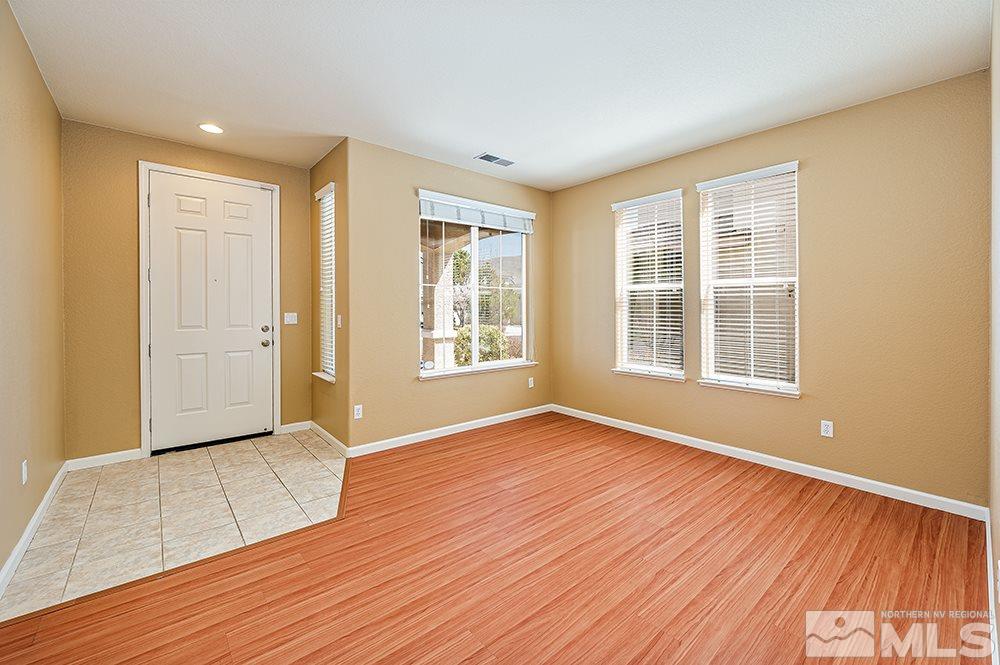 1778 Cavern Drive Reno, NV 89521 - Photo 7 of 15 a view of an empty room with wooden floor and a window