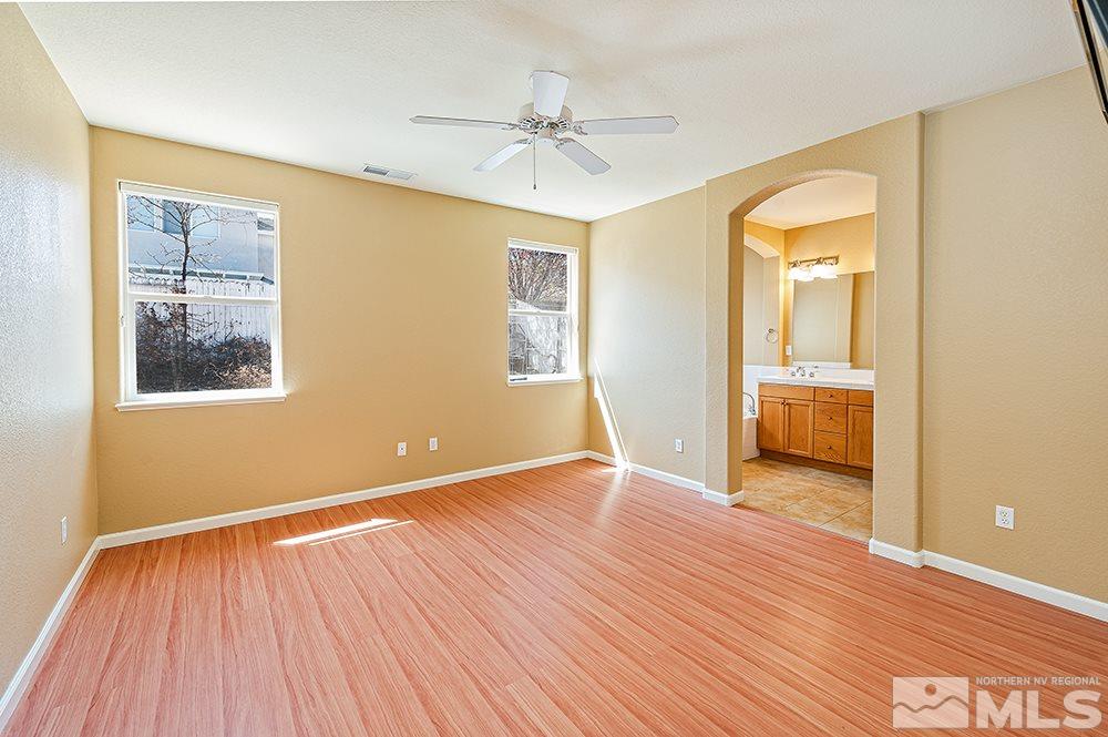 1778 Cavern Drive Reno, NV 89521 - Photo 8 of 15 a view of an empty room with wooden floor and a window