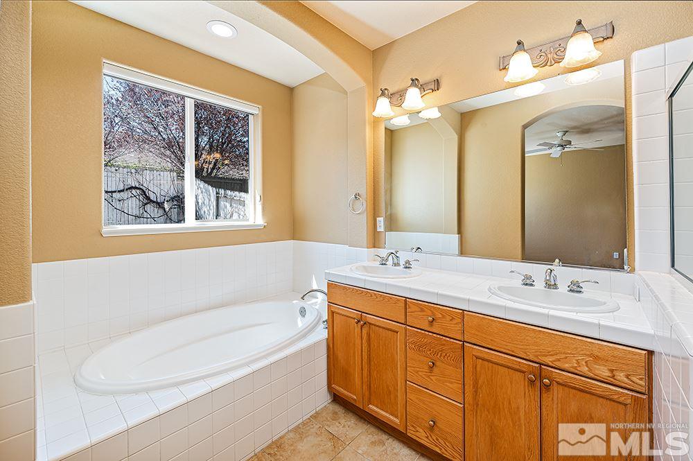 1778 Cavern Drive Reno, NV 89521 - Photo 9 of 15 a bathroom with a double vanity sink mirror and bathtub