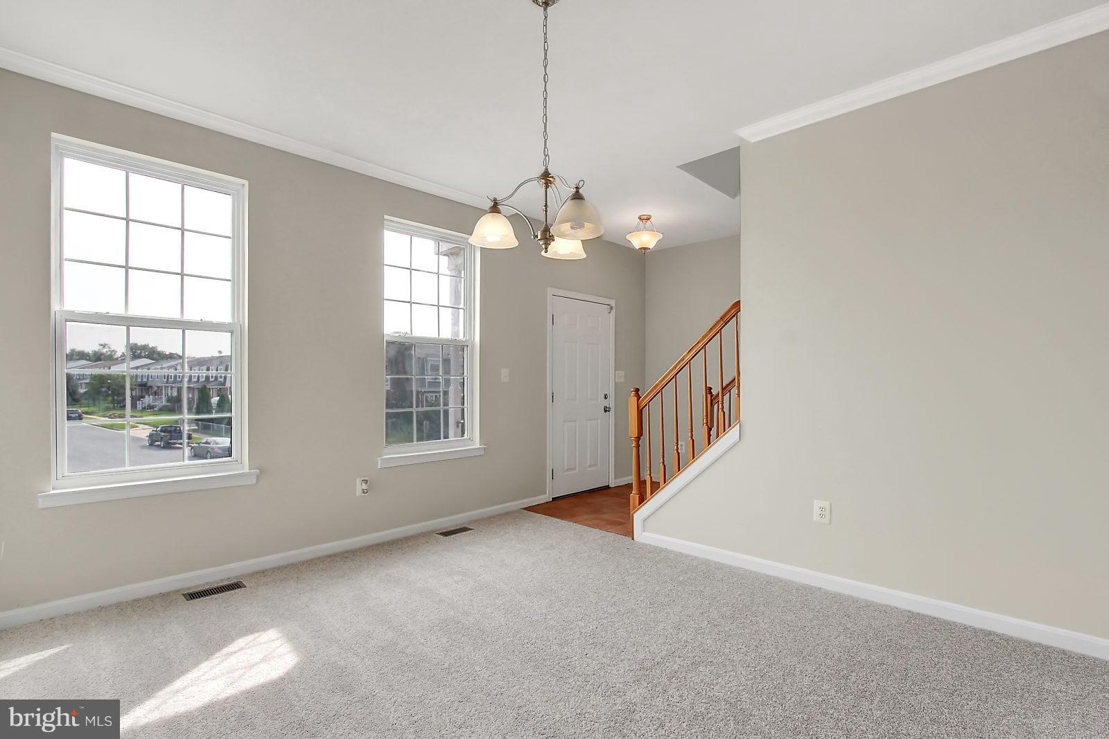 532 Grovethorn Road Baltimore, MD 21220 - Photo 11 of 30 an empty room with windows and chandelier