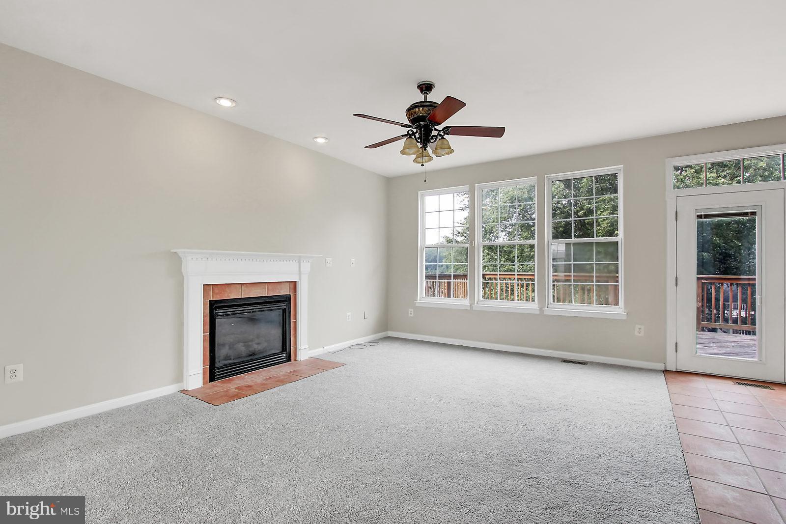 532 Grovethorn Road Baltimore, MD 21220 - Photo 15 of 30 a view of an empty room with a fireplace and a window