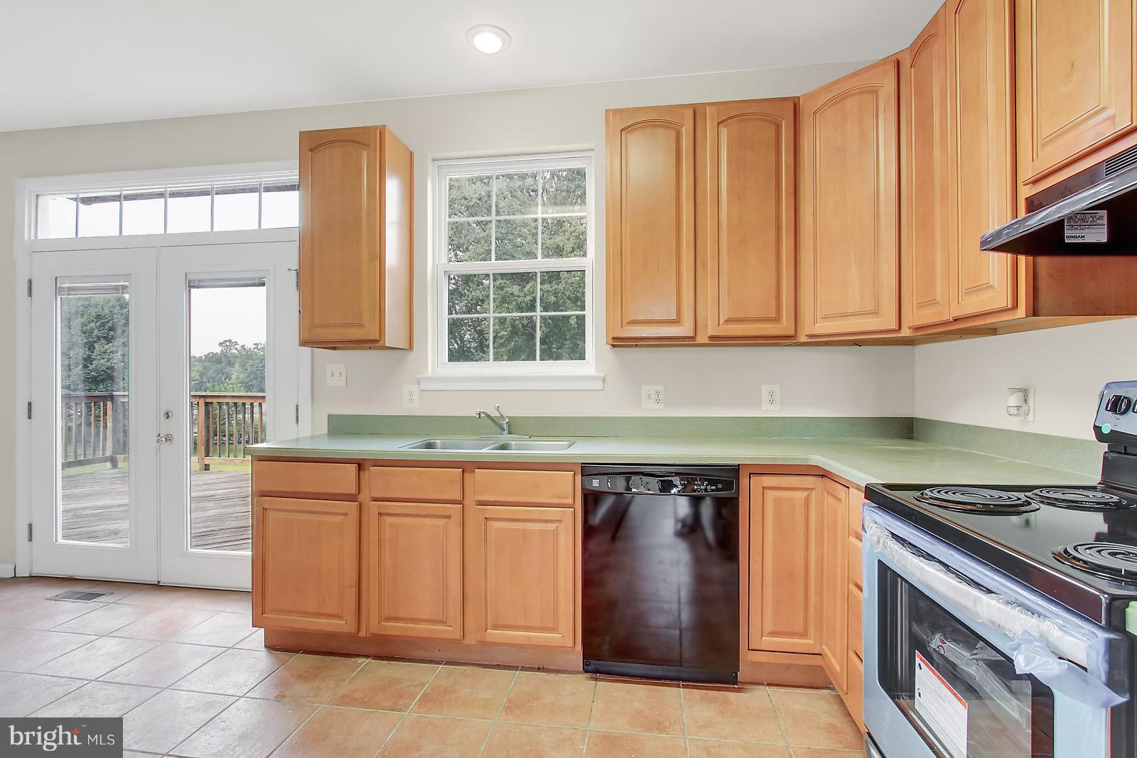 532 Grovethorn Road Baltimore, MD 21220 - Photo 3 of 30 a kitchen with stainless steel appliances granite countertop a sink stove and cabinets