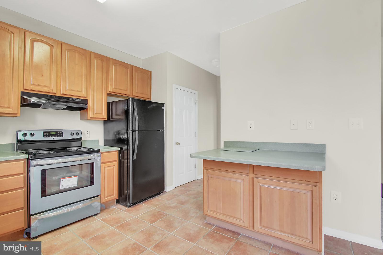 532 Grovethorn Road Baltimore, MD 21220 - Photo 4 of 30 a kitchen with stainless steel appliances granite countertop a refrigerator stove and sink
