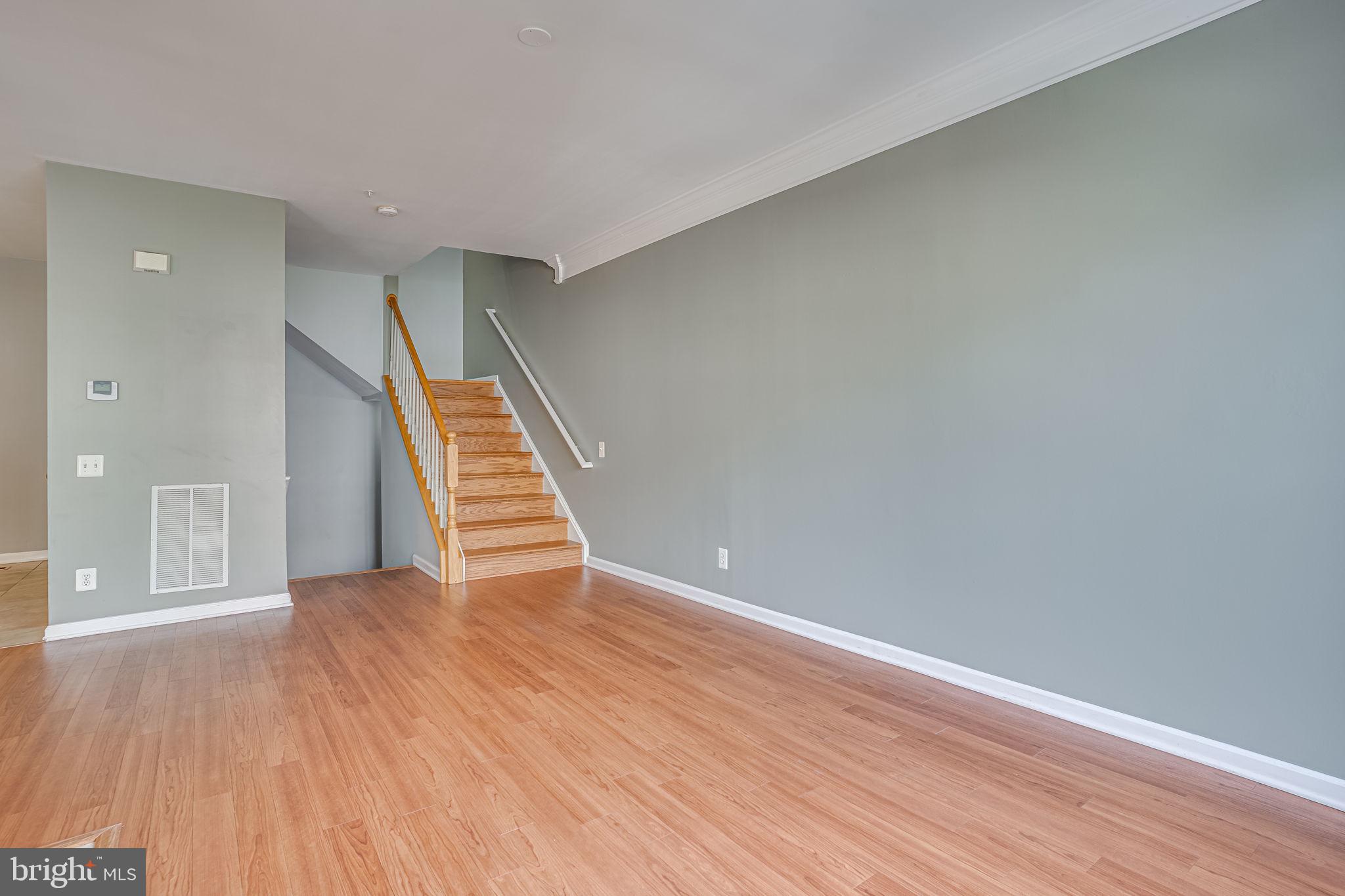 6321 Eagle Ridge Lane, Unit B Alexandria, VA 22312 - Photo 11 of 39 a view of an empty room with wooden floor and stairs