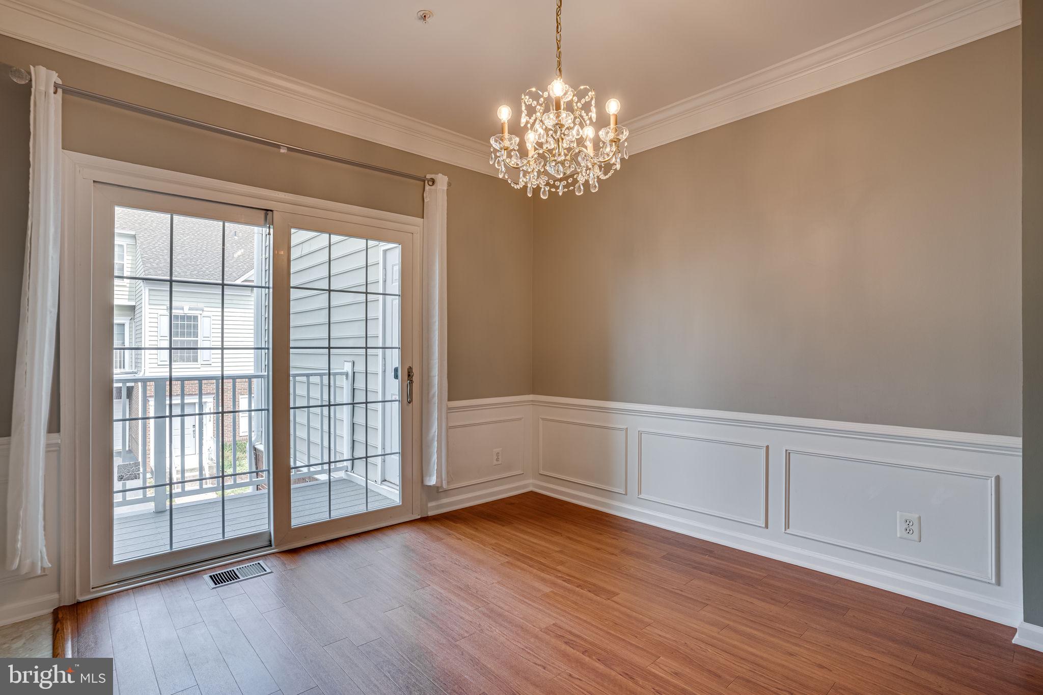 6321 Eagle Ridge Lane, Unit B Alexandria, VA 22312 - Photo 12 of 39 a view of an empty room with wooden floor and a window