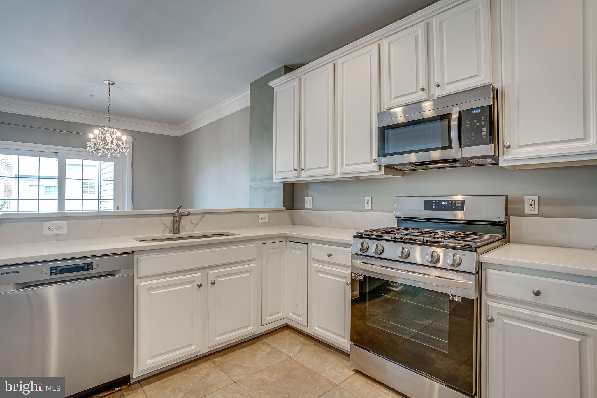 6321 Eagle Ridge Lane, Unit B Alexandria, VA 22312 - Photo 15 of 39 a kitchen with cabinets stainless steel appliances a sink and a stove