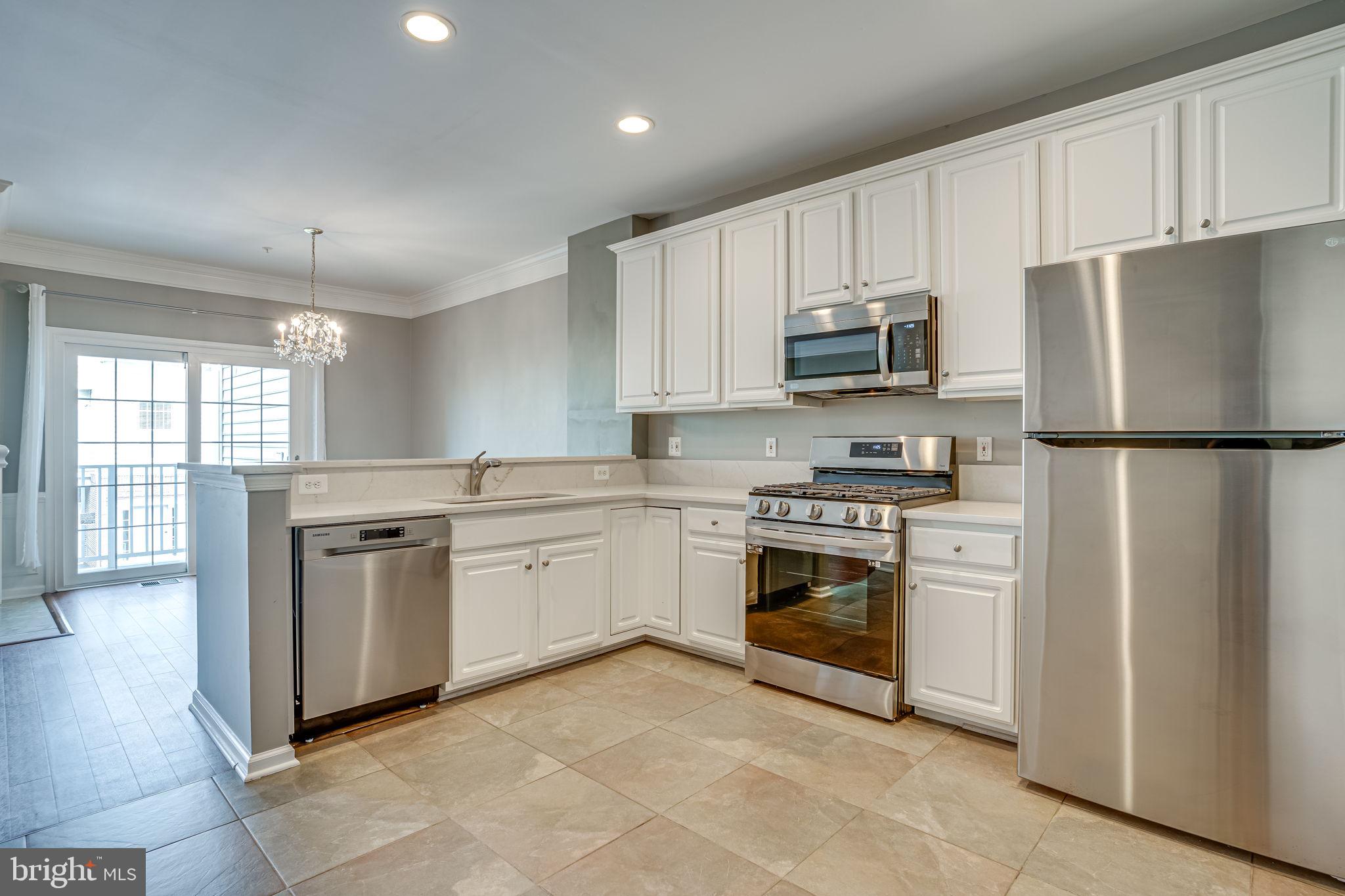 6321 Eagle Ridge Lane, Unit B Alexandria, VA 22312 - Photo 17 of 39 a kitchen with granite countertop white cabinets and stainless steel appliances
