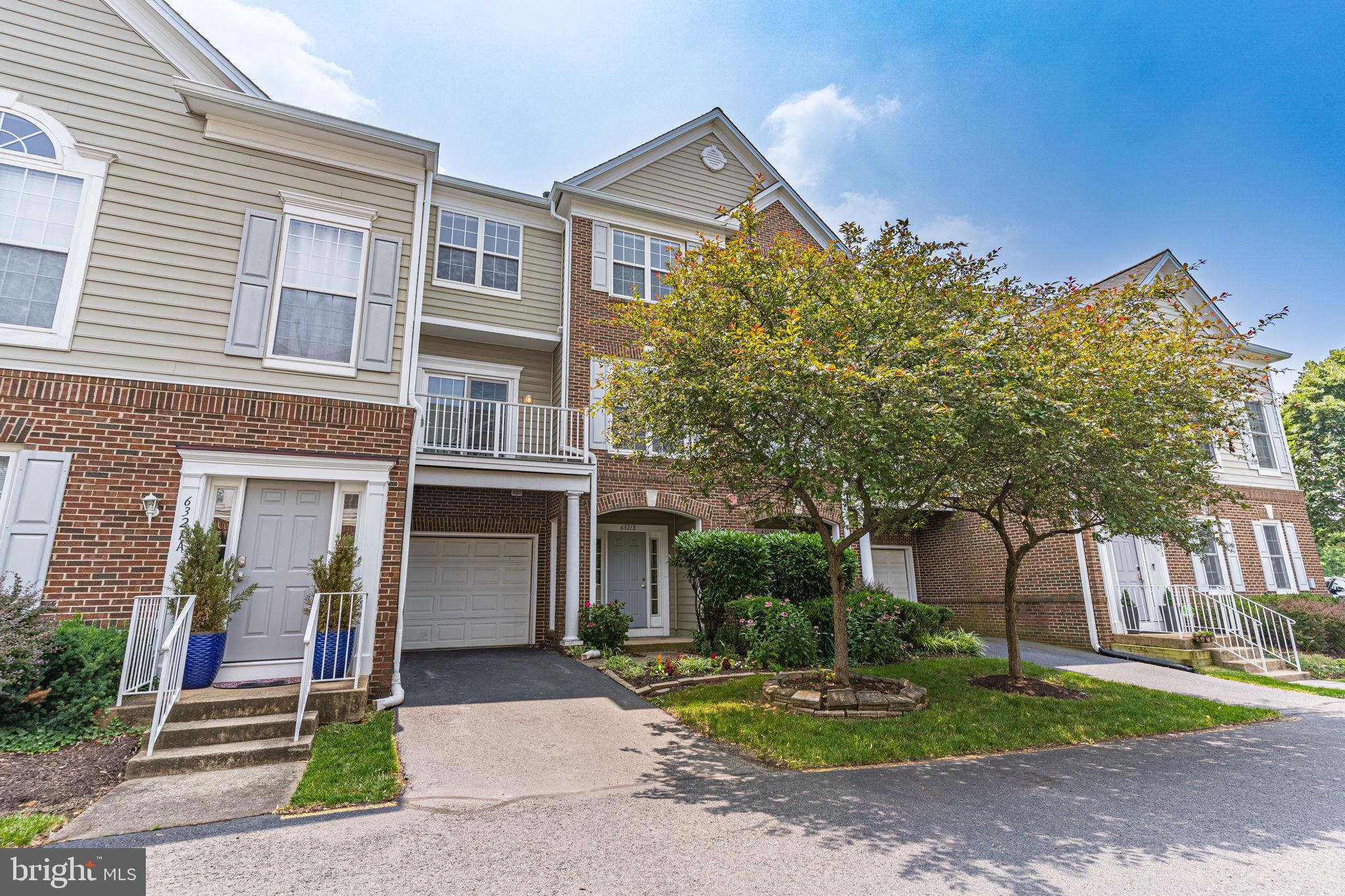 6321 Eagle Ridge Lane, Unit B Alexandria, VA 22312 - Photo 2 of 39 a front view of a house with a yard and tree s