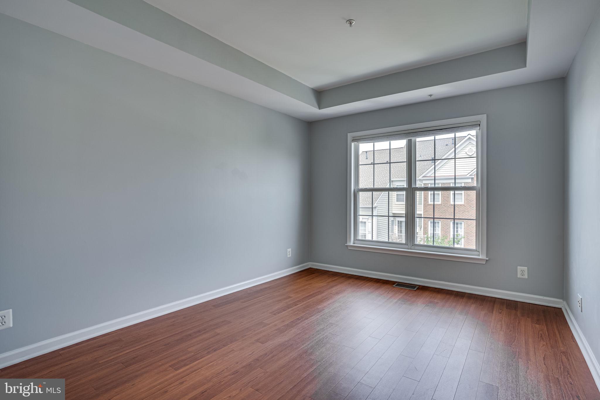6321 Eagle Ridge Lane, Unit B Alexandria, VA 22312 - Photo 21 of 39 an empty room with wooden floor and windows