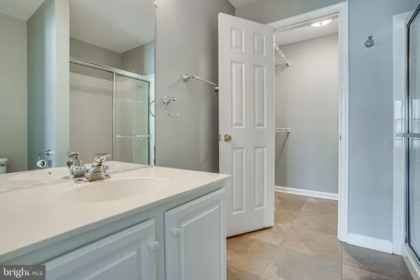 a bathroom with a sink vanity and a mirror