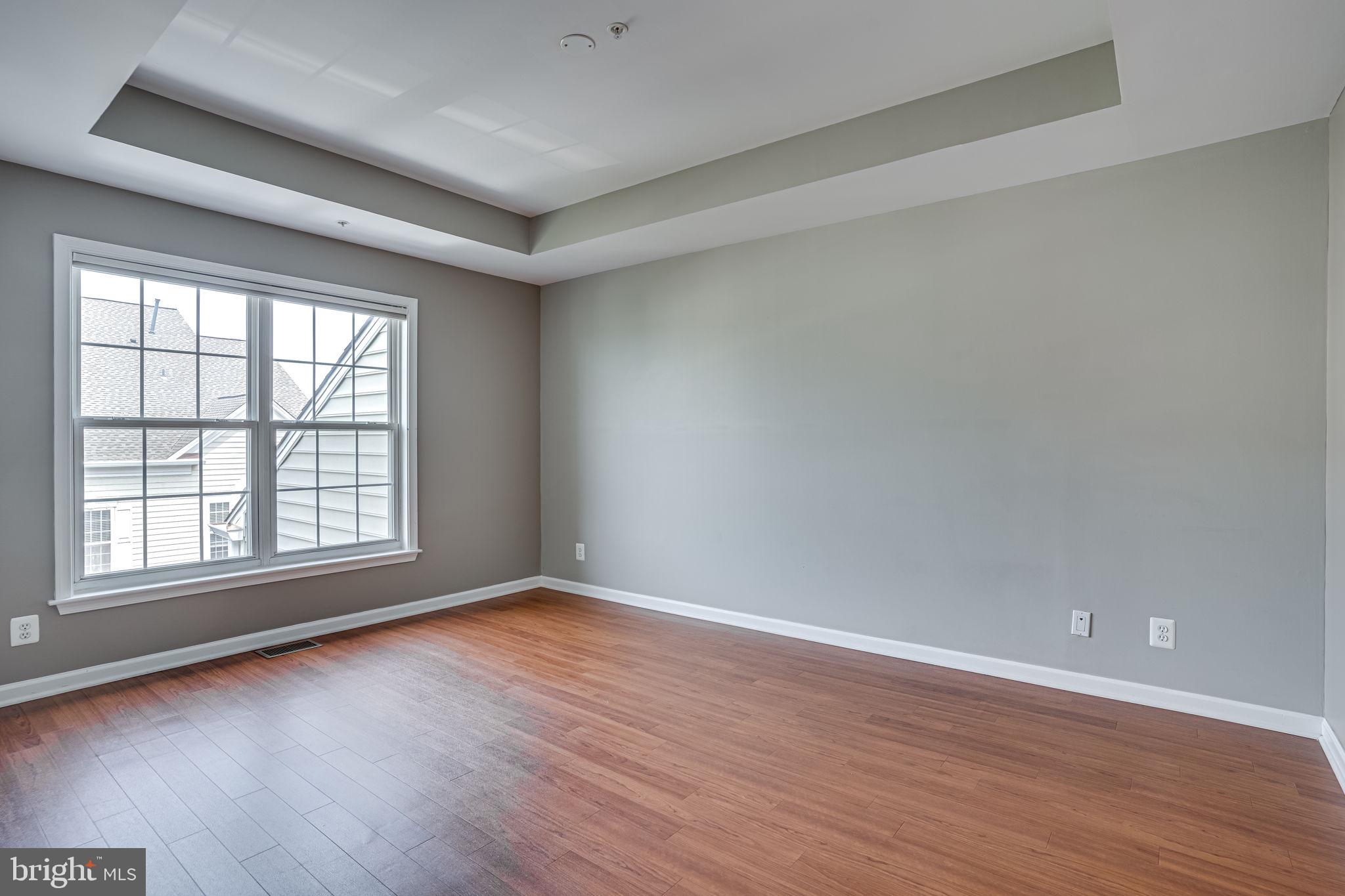 6321 Eagle Ridge Lane, Unit B Alexandria, VA 22312 - Photo 26 of 39 wooden floor in an empty room with a window
