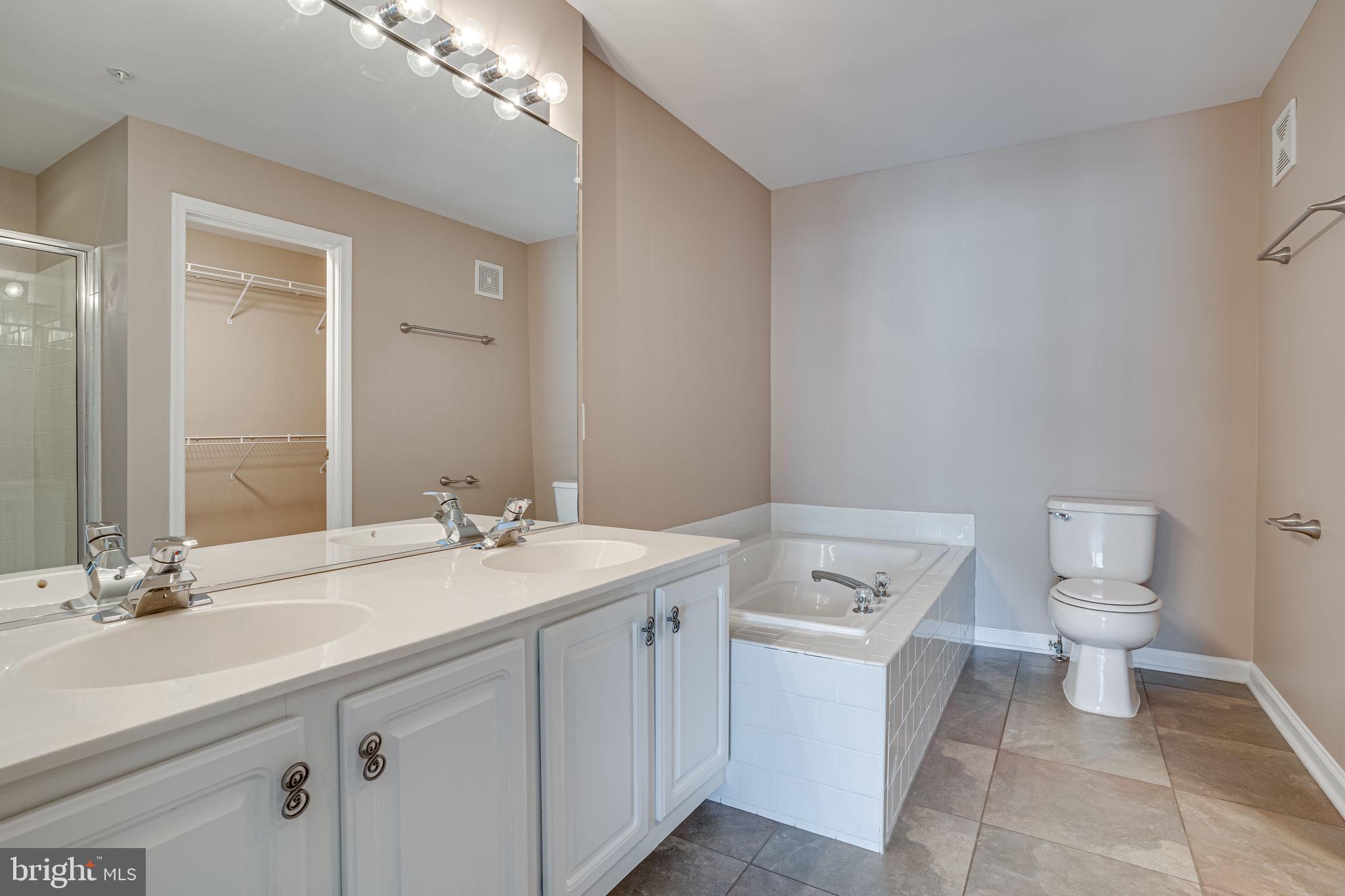 6321 Eagle Ridge Lane, Unit B Alexandria, VA 22312 - Photo 30 of 39 a bathroom with a sink a toilet and a mirror