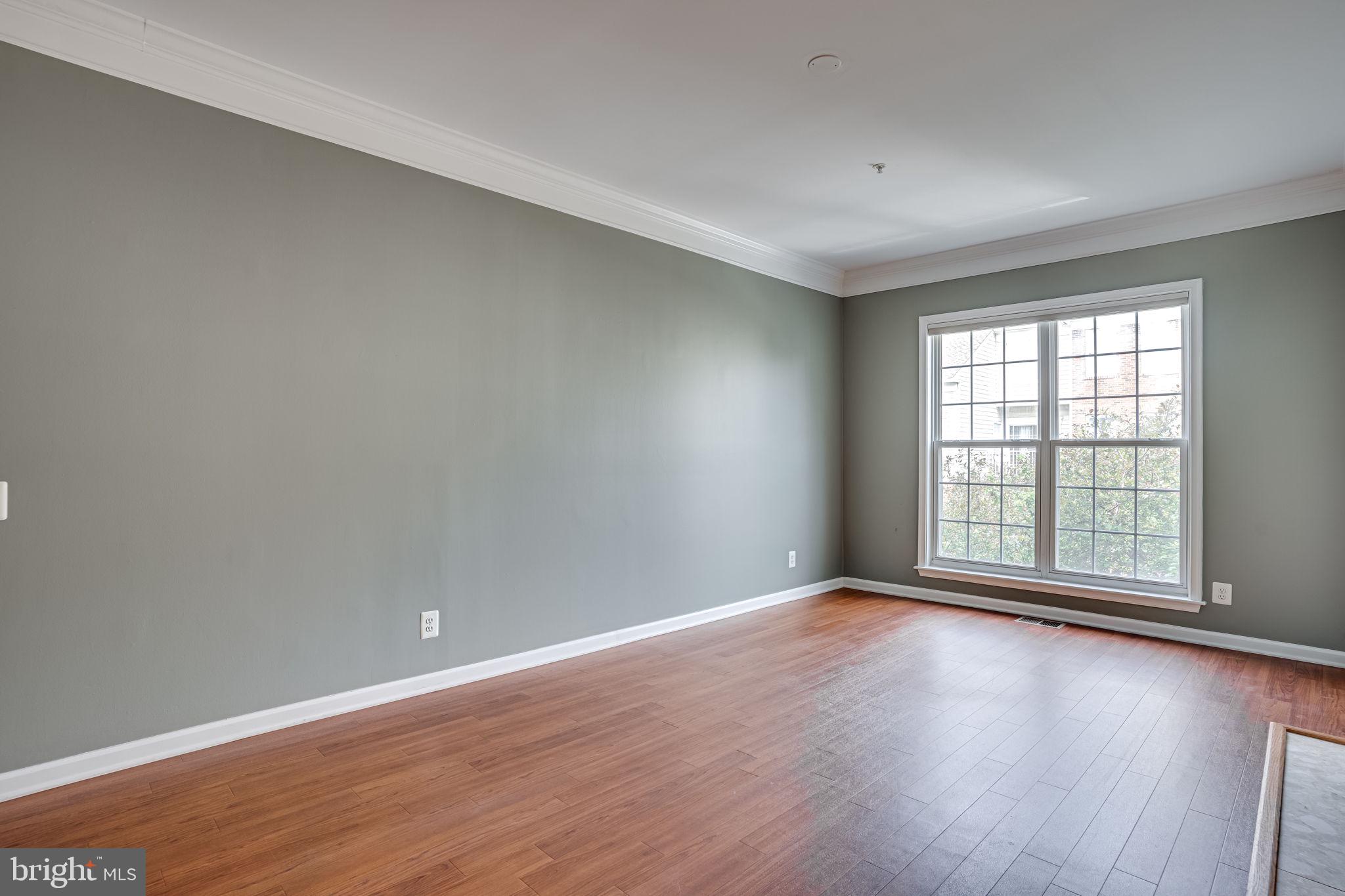 6321 Eagle Ridge Lane, Unit B Alexandria, VA 22312 - Photo 10 of 39 wooden floor in an empty room with a window