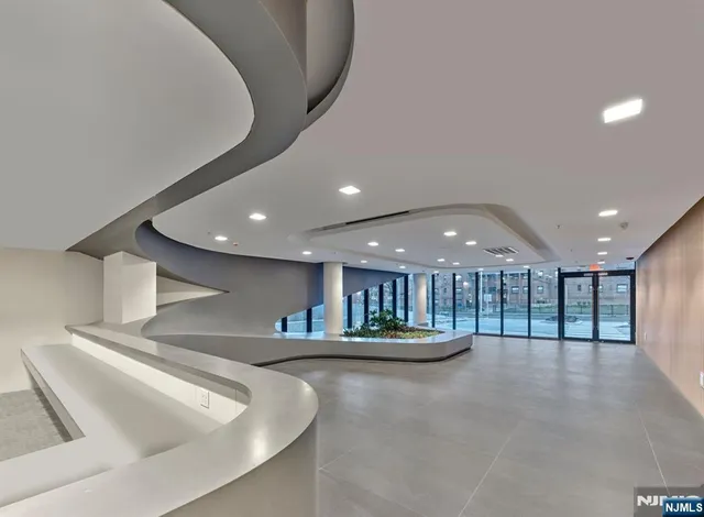 a view of kitchen with a sink and a large mirror