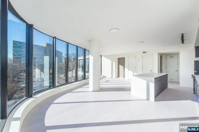 a spacious bedroom with a large bed and a large window