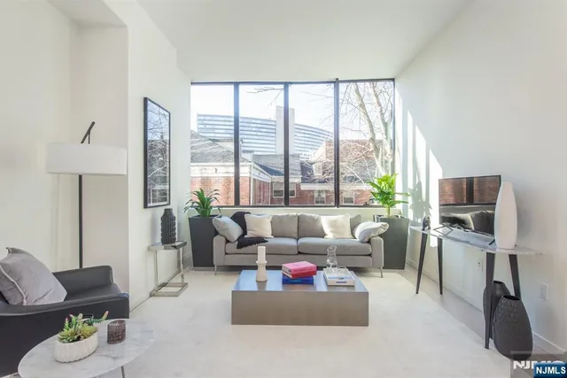 a living room with furniture and a floor to ceiling window