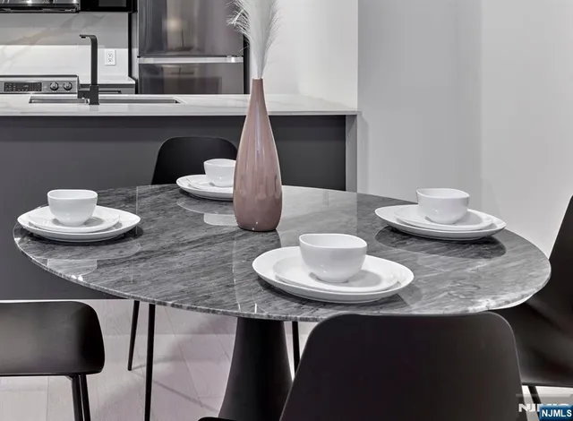 a dining room with two chairs and a table