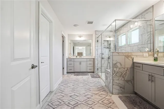 a bathroom with a sink a mirror and a shower