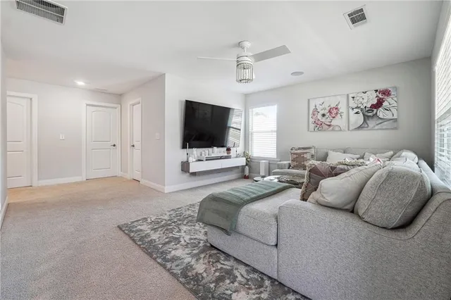 a spacious bedroom with a bed and a flat screen tv