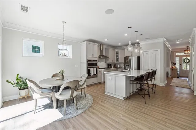 a view of a dining room with furniture and wooden floor