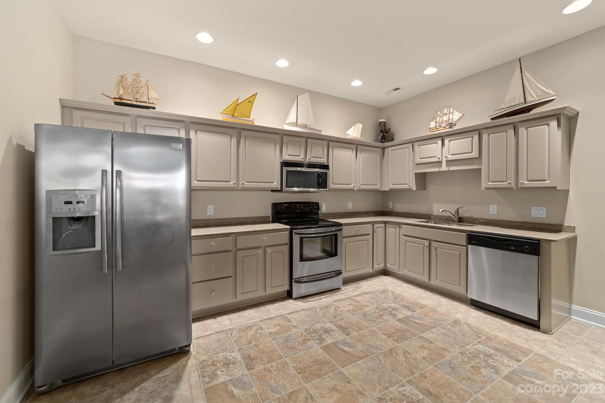 8065 Bay Pointe Drive Denver, NC 28037 - Photo 27 of 40 a kitchen with stainless steel appliances granite countertop a refrigerator and a stove top oven