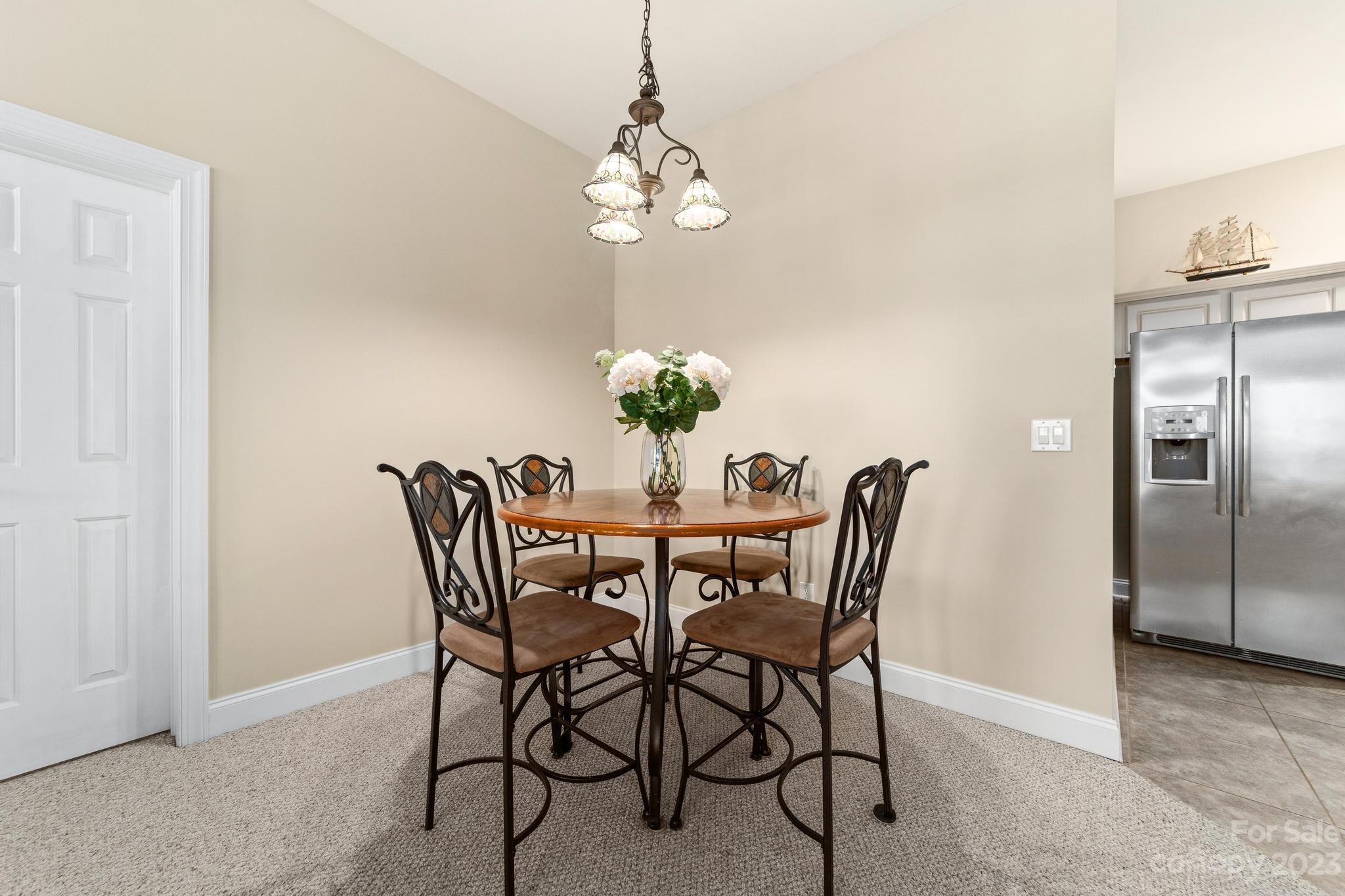 8065 Bay Pointe Drive Denver, NC 28037 - Photo 28 of 40 a view of a dining room with furniture and chandelier