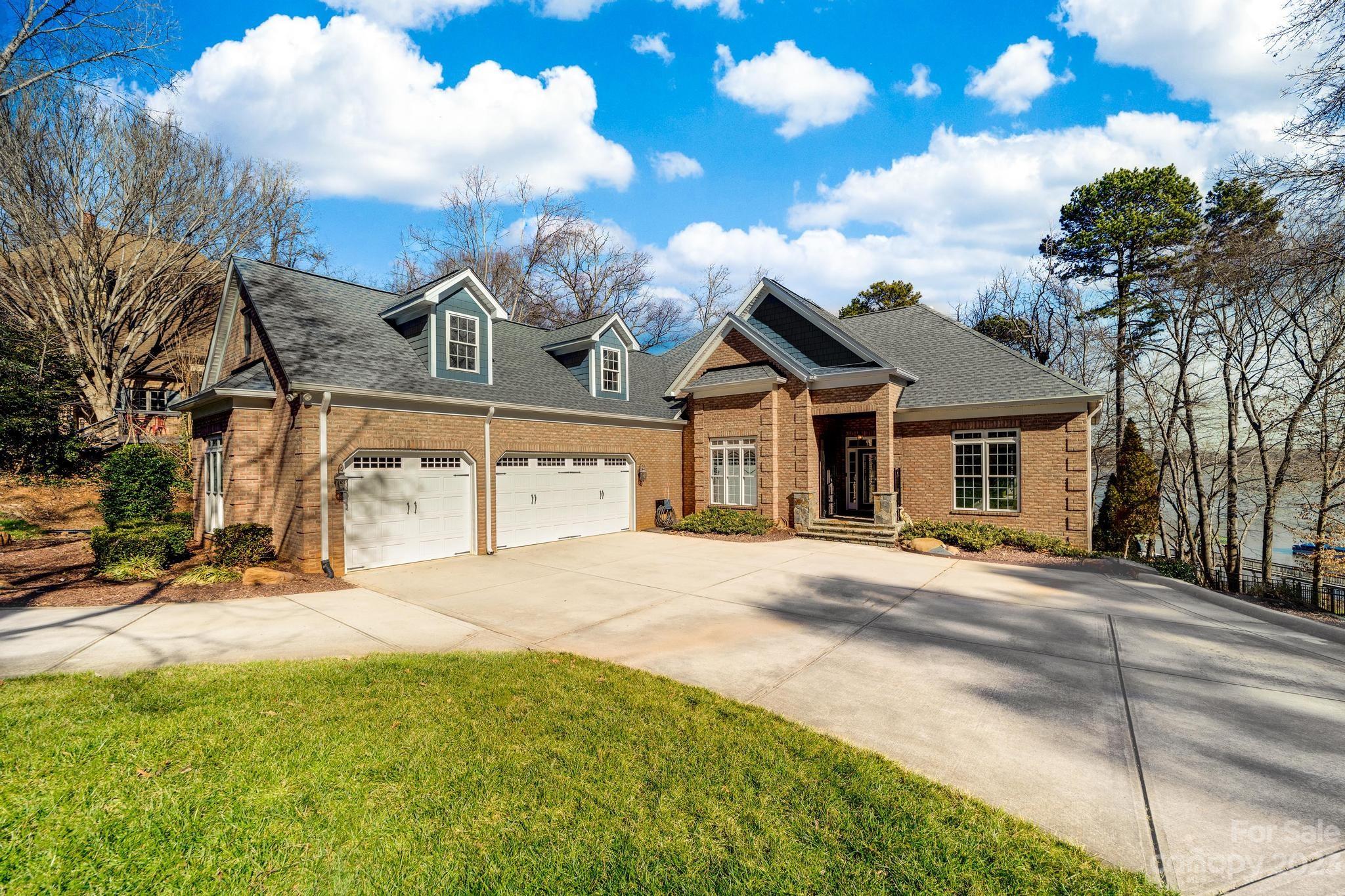 8065 Bay Pointe Drive Denver, NC 28037 - Photo 4 of 40 a front view of a house with a yard and garage