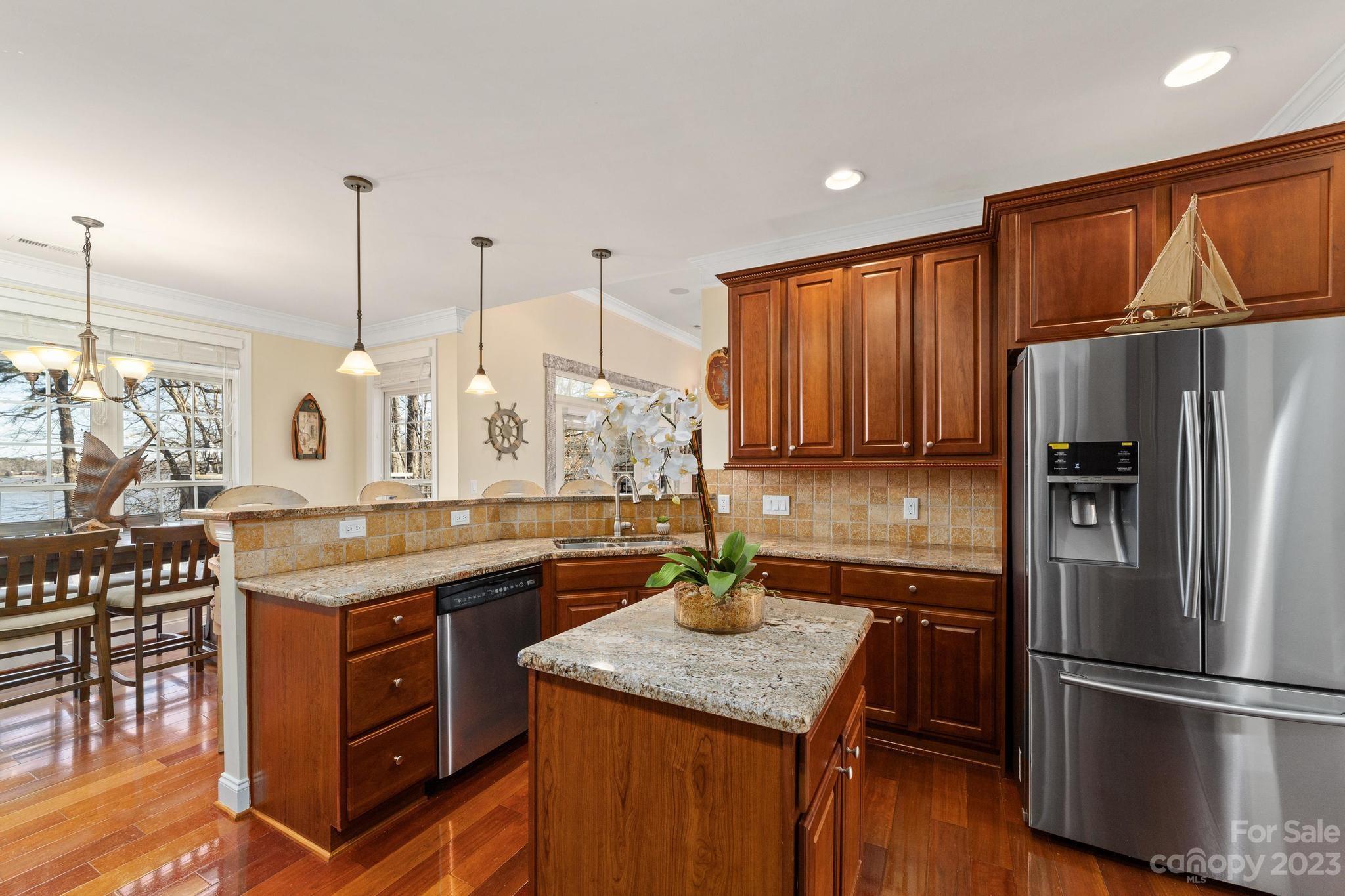 8065 Bay Pointe Drive Denver, NC 28037 - Photo 9 of 40 a kitchen with stainless steel appliances granite countertop a sink stove and refrigerator