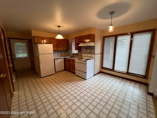a kitchen with a refrigerator stove and sink